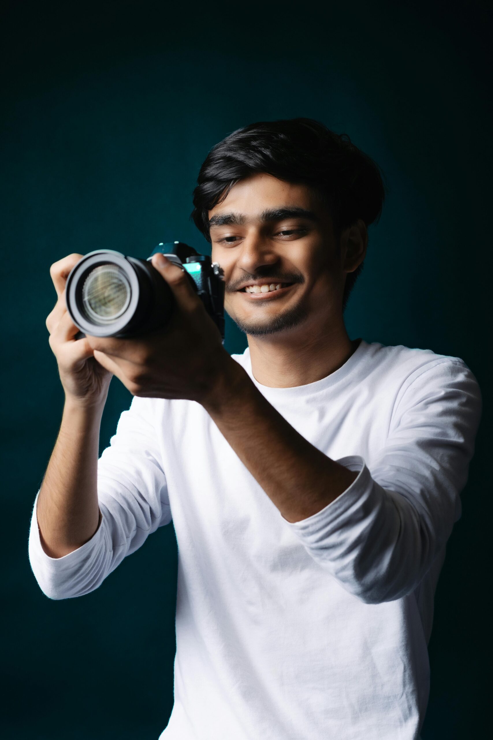 A portrait of a photographer holding a camera, representing photography, creativity, media profession, and modern lifestyle